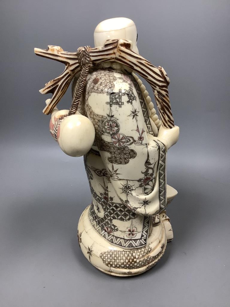 A Chinese engraved and stained bone figure of Budai, height 29cm